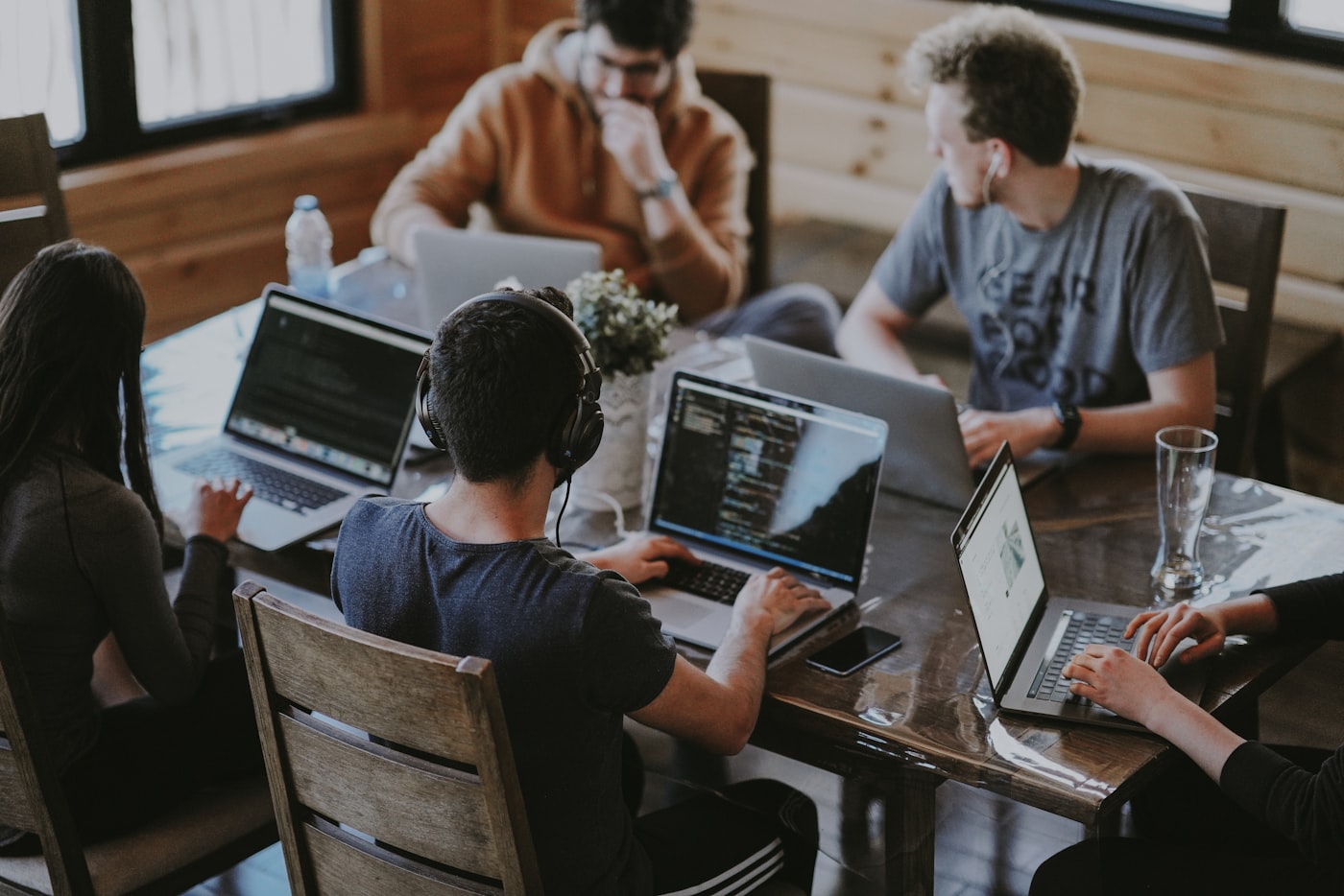 Technologists collaborating around a shared table